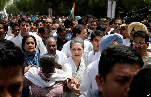 India's opposition Congress party president Sonia Gandhi, front centre, accompanied by her son and party vice-president Rahul Gandhi, behind, lead a march against the ruling Bharatiya Janata Party (BJP) government in New Delhi, India on May 6, 2016.