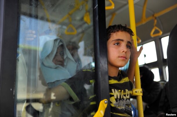 Civilians ride a bus to be evacuated from the besieged Damascus suburb of Daraya, after an agreement reached on Thursday between rebels and Syria's army, Syria, August 26, 2016.