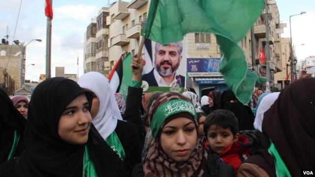 Hamas supporters, some carrying posters of the group's leader, Khaled Meshaal, rally in the West Bank, December 14, 2012. (VOA/R. Collard)