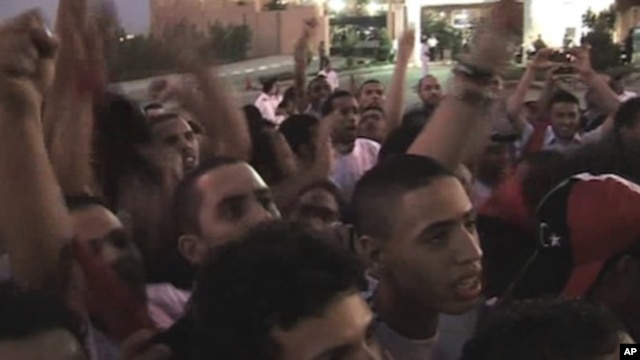Libyans in Martyr's Square in Tripoli  watch their national football team compete under the country's new flag, Saturday, Sept. 3, 2011.