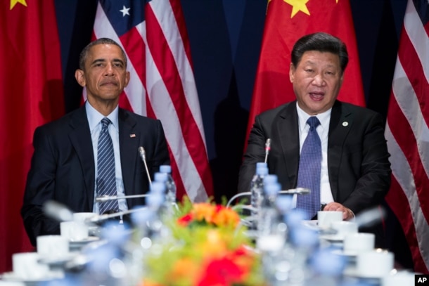 FILE - President Barack Obama, left, meets with Chinese President Xi Jinping outside Paris, Nov. 30, 2015.