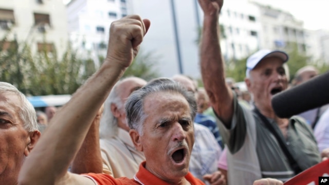 A pensioner shouts slogans during an anti-austerity protest in front of the EU headquarters in Athens, October 8, 2012.