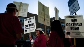 Public school teachers picket outside Amundsen High School in Chicago on the first day of a strike by the Chicago Teachers Union, Monday, Sept. 10, 2012.