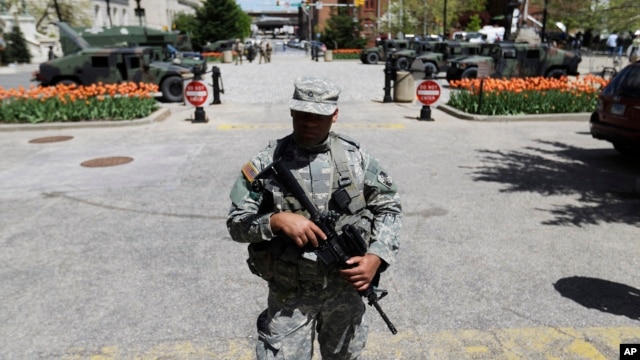 A National Guardsman stands outside the City Hall in Baltimore, April 29, 2015.