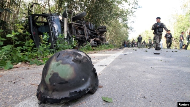 Policemen and rescue workers gather at the site of an attack on army in the troubled southern province of Yala February 10, 2013.
