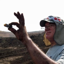 Paul Nascimbene holds up ancient amber found in India.