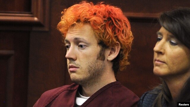 Colorado shooting suspect James Eagan Holmes (L) sits with public defender Tamara Brady during his first court appearance in Aurora, Colorado, July 23, 2012.
