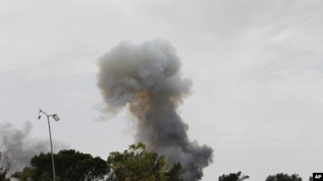Smoke rises after an explosion, the cause of which was unclear, on Misrata's western front line, June 11, 2011