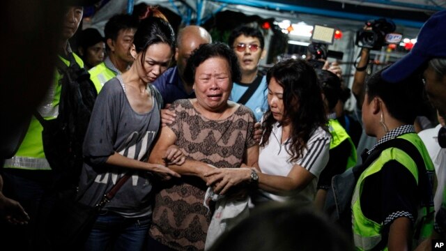 Thân nhân và bạn bè của hai nạn nhân người Malaysia Lim Saw Gaik, 49 tuổi và Neoh Jai Jun, 20 tuổi, đến chia buồn với gia quyến tại Penang, Malaysia, ngày 20/8/2015.