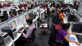 Workers are seen at their workstations on the floor of an outsourcing centre in Bangalore, February 29, 2012.