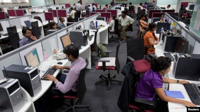 Workers are seen at their workstations on the floor of an outsourcing centre in Bangalore, February 29, 2012.