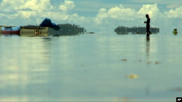 This man ponders his fate as he looks out to Huene, an island in the Carteret bisected by the sea 20 years ago.
