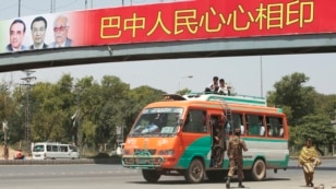 A soldier walks near a bus as he helps to secure the area and clear the roads before the motorcade of Chinese Premier Li Keqiang passes by in Islamabad, May 22, 2013. 
