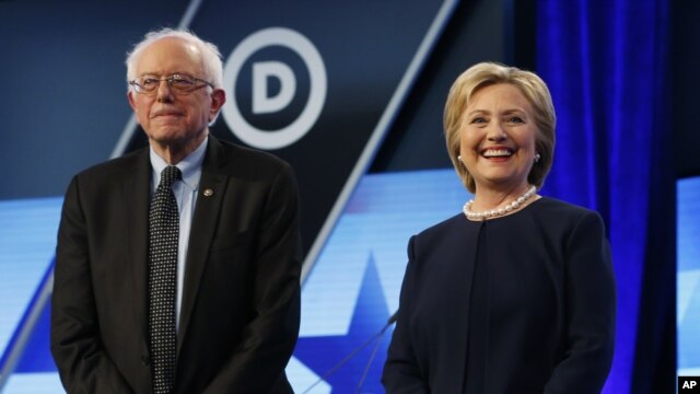 Democratic presidential candidates, Hillary Clinton and Sen. Bernie Sanders, I-Vt,  stand together before the start of the Univision, Washington Post Democratic presidential debate at Miami-Dade College,  March 9, 2016.