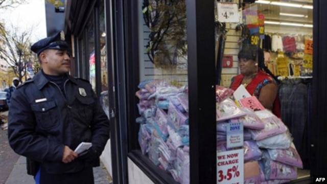 Officer L.A. Sanchez walks a beat in a downtown shopping area in Camden, New Jersey, in November 2010. "The Camden Police Department will not abandon its community policing philosophy," said Chief Scott Thomson, even as the department and other city agenc