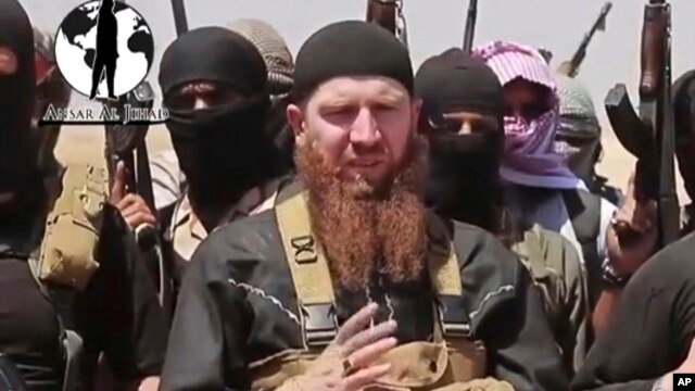 FILE - Islamic State commander Omar al-Shishani (C), aka Omar the Chechen, is seen in an image made from undated video posted June 28, 2014, on a social media account frequently used for communications by the jihadist group.