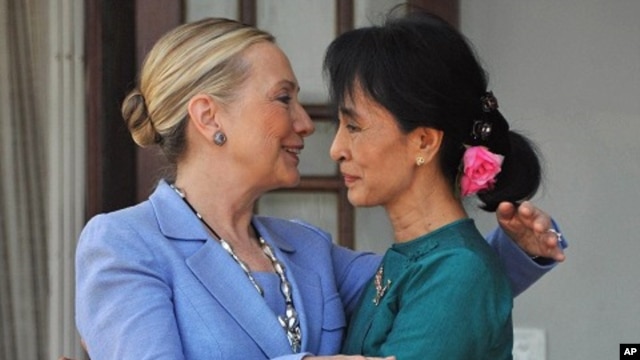 Burmese democracy leader Aung San Suu Kyi (R) greets visiting US Secretary of State Hillary Clinton following their meeting at Suu Kyi's residence in Rangoon, December 2, 2011.