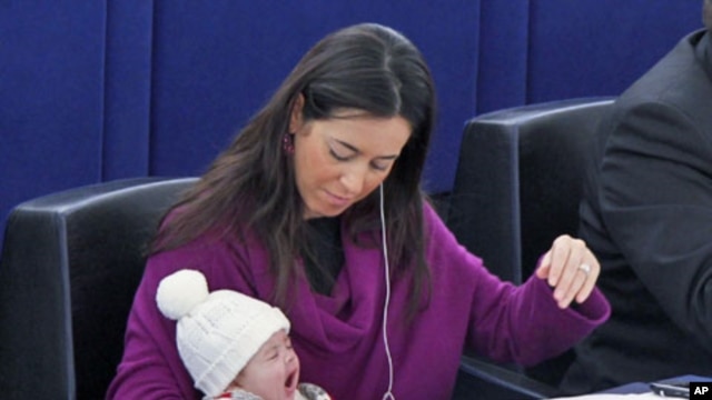 Italy's Member of the European Parliament Licia Ronzulli takes part with her baby in a voting session at the European Parliament in Strasbourg December 16, 2010