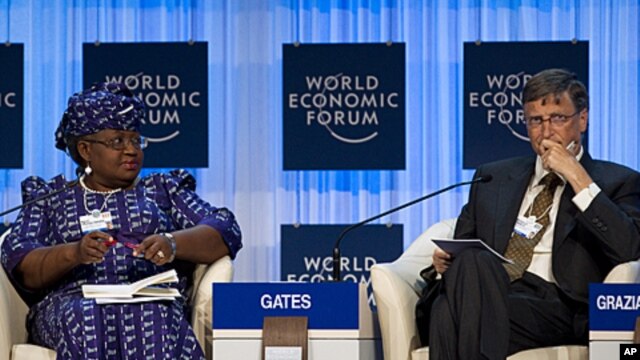 Bill Gates, right, and Nigerian Finance Minister Ngozi Okonjo-Iweala attend a panel session at the World Economic Forum in Davos, January 26, 2012.