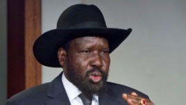 South Sudan's President Salva Kiir, shown here after meeting with Sudan's President Omar al-Bashir in Juba in January, has restored 6 government ministries. 