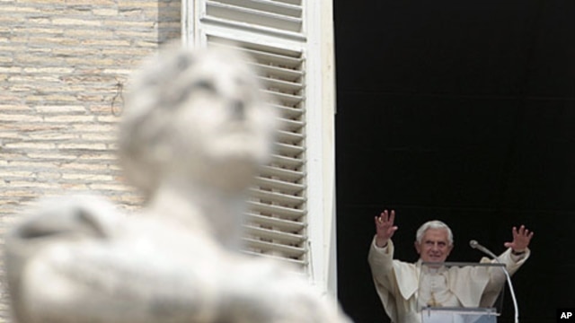 Pope Benedict XVI acknowledges the crowd during a prayer from his studio window overlooking St. Peter's Square at the Vatican, Sunday, May 15, 2011