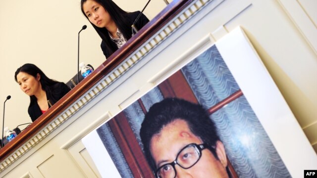 FILE - Zhang Qing, left, wife of Chinese human rights activist Guo Feixiong, and daughter Yang Tianjiao speak at a press conference before a hearing of a House Foreign Affairs Committee subcommittee in Washington, D.C., October 29, 2013.