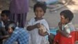 Indian street children eat food at a shanty town in Hyderabad.