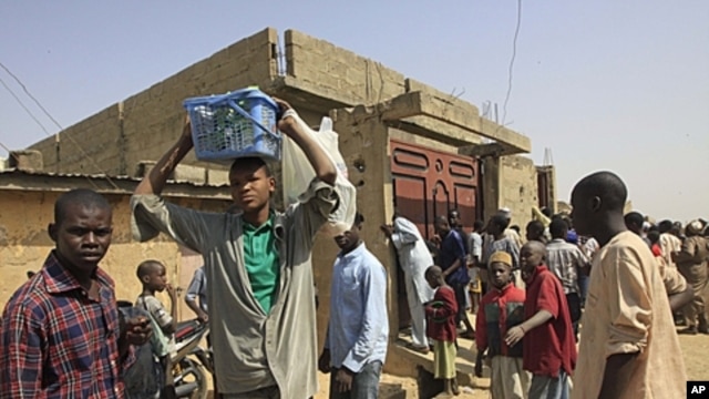 Witnesses at the house in Kano, Nigeria,  security forces surrounded the house, forcing their way inside, killing a man and a pregnant woman while searching for members of a radical Islamist sect known as Boko Haram, January 24, 2012.