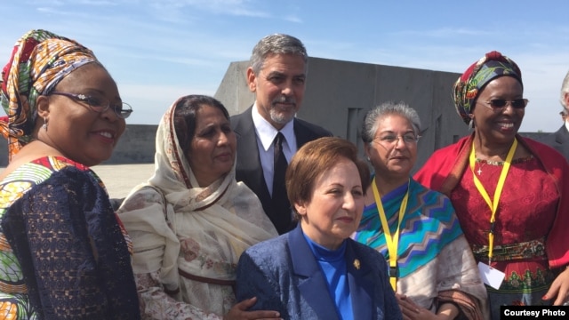 Renowned hollywood actor George Clooney takes a group photo with a group of women during his visit to attend global forum of “Against the Crime of Genocide” in Armenia in late April, 2016. (Photo supplied by Youk Chhang)