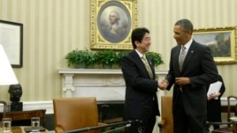 President Barack Obama shakes hands with Japan's Prime Minister Shinzo Abe at the end of their meeting in the Oval Office of the White House in Washington, Feb. 22, 2013.