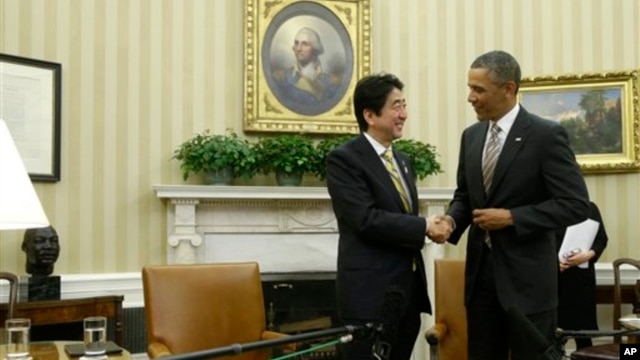 President Barack Obama shakes hands with Japan's Prime Minister Shinzo Abe at the end of their meeting in the Oval Office of the White House in Washington, Feb. 22, 2013.