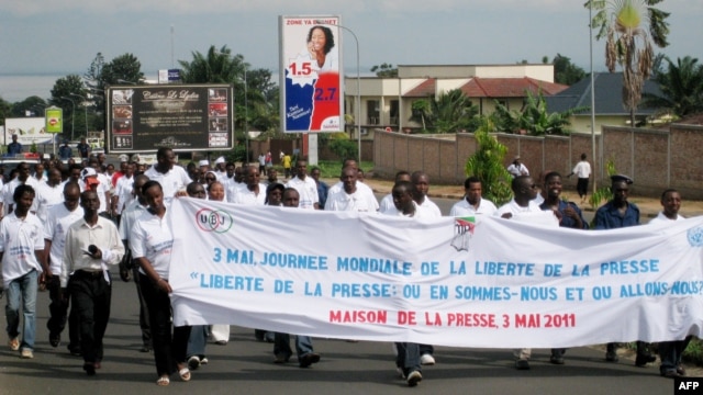 Burundian journalists carry a banner as they march in the streets of Burundi's capital Bujumbura, May 3, 2011. 