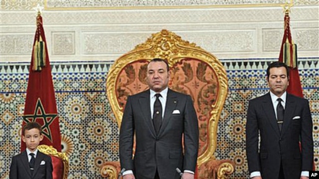 In this photo released by the Royal Palace, Morocco's King Mohamed VI flanked by his son Moulay El Hassan, left ,and his Brother Prince Moulay Rachid, right , listens to the national anthem after he delivered a speech to the nation, March, 9, 2011, at the