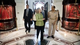 Field Marshal Hussein Tantawi walks with U.S. Secretary of State Hillary Clinton at the Ministry of Defense in Cairo, Egypt, July 15, 2012. 