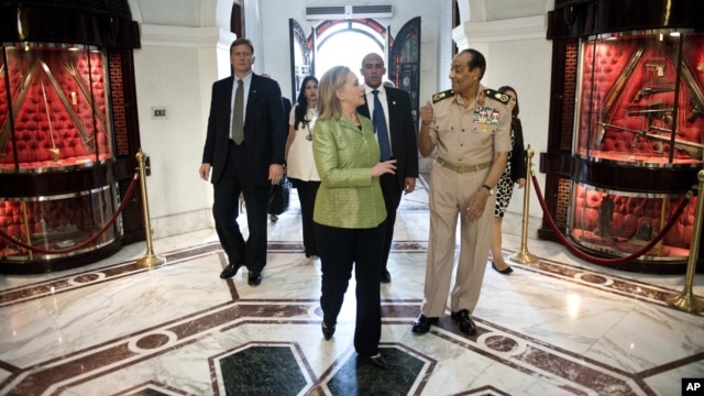 Field Marshal Hussein Tantawi walks with U.S. Secretary of State Hillary Clinton at the Ministry of Defense in Cairo, Egypt, July 15, 2012. 