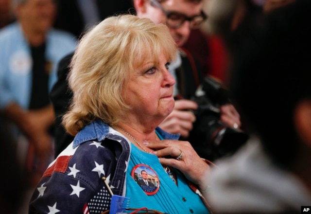 A supporter watches as returns come in during a caucus night rally for Republican presidential candidate Sen. Ted Cruz of Texas, Feb. 23, 2016.
