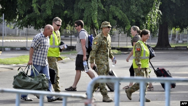 Australian troops accompany U.N. officials leaving East Timor through Dili's airport, December 31, 2012.