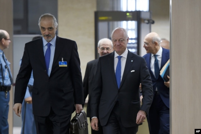 Syrian Ambassador to the U.N. and Head of the Government delegation Bashar al-Jaafari, left, and U.N. Special Envoy for Syria Staffan de Mistura, right, arrive at peace-talks at the U.N. office in Geneva, March 16, 2016.