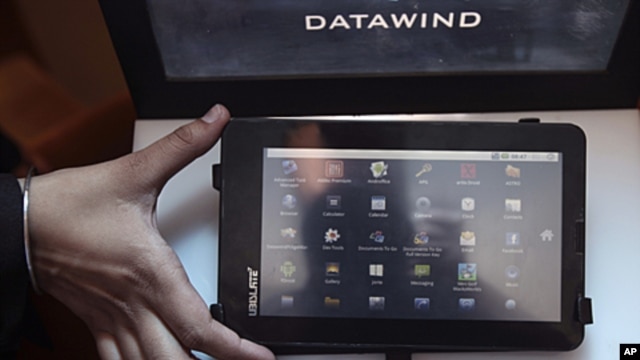 A DataWind representative displays the supercheap 'Aakash' Tablet computers during its launch in  New Delhi, India. The $35 basic touchscreen tablet aimed at students can be used for functions like word processing, web browsing and video conferencing. 'Aa