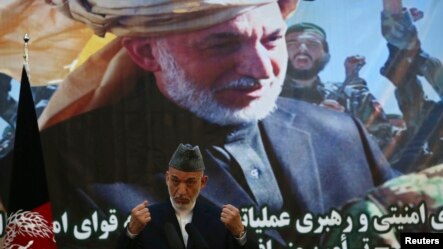  Afghan President Hamid Karzai speaks during a joint news conference with NATO Secretary General Anders Fogh Rasmussen following a security handover ceremony at a military academy outside Kabul, Afghanistan, June 18, 2013.