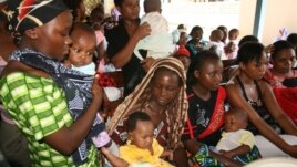 Women and their children visit a clinic at Sinza Health Centre in Tanzania's capital Dar es Salaam May 2, 2011. 
