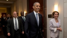 President Barack Obama walks with House Minority Leader Nancy Pelosi of Calif., right and House Minority Assistant Leader James Clyburn of S.C., as he visits Capitol Hill in Washington, June 12, 2015.