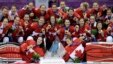 Team Canada gathers for a group photo after beating the USA 3-2 in overtime of the gold medal women&#39;s ice hockey game at the 2014 Winter Olympics, Feb. 19, 2014, in Sochi, Russia.