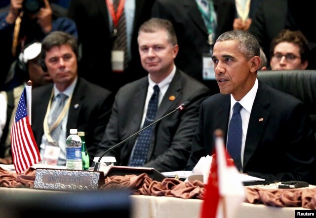 FILE - U.S. President Barack Obama, right, delivers remarks at the US-ASEAN meeting at the ASEAN Summit in Kuala Lumpur, Malaysia, Nov. 21, 2015.