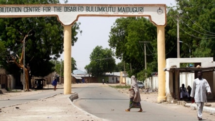 A woman crosses a deserted road in Bulumkutu, after the military declared a 24-hour curfew over large parts of Maiduguri in Borno State May 19, 2013.