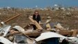 Dr. Amanda Theys sorts through the rubble of the tornado-ravaged medical clinic she works at in Moore, Oklahoma,  May 21, 2013. 
