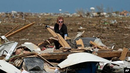 Dr. Amanda Theys sorts through the rubble of the tornado-ravaged medical clinic she works at in Moore, Oklahoma,  May 21, 2013. 