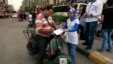 An Egyptian on his motorbike signs a petition for Tamarod, Arabic for "rebel", a campaign calling for the ouster of Egyptian President Mohammed Morsi and for early presidential elections in the Shubra neighborhood in Cairo, Egypt, June 2, 2013. 