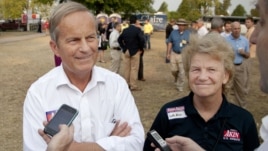Representative Todd Akin of Missouri and his wife Lulli talk with reporters in the town of Sedalia.