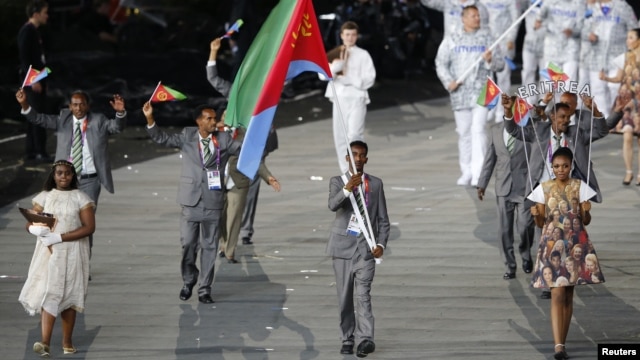 Eritrea's flag bearer Weynay Ghebresilasie holds the national flag as he leads the contingent in the athletes parade during the opening ceremony of the London 2012 Olympic Games, July 27, 2012.                                 